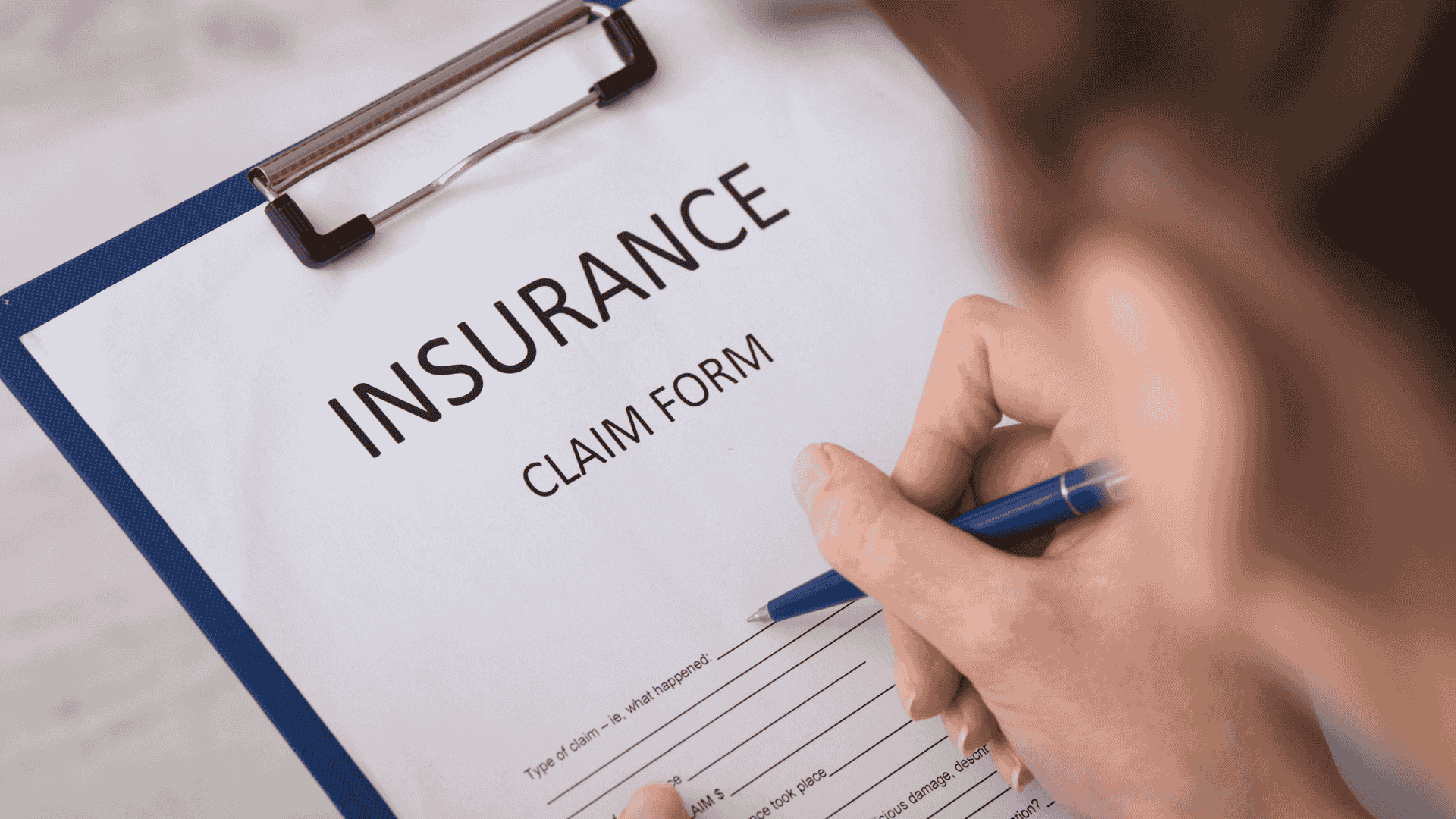 homeowner filling out insurance claim form for roof damage Dallas Fort Worth