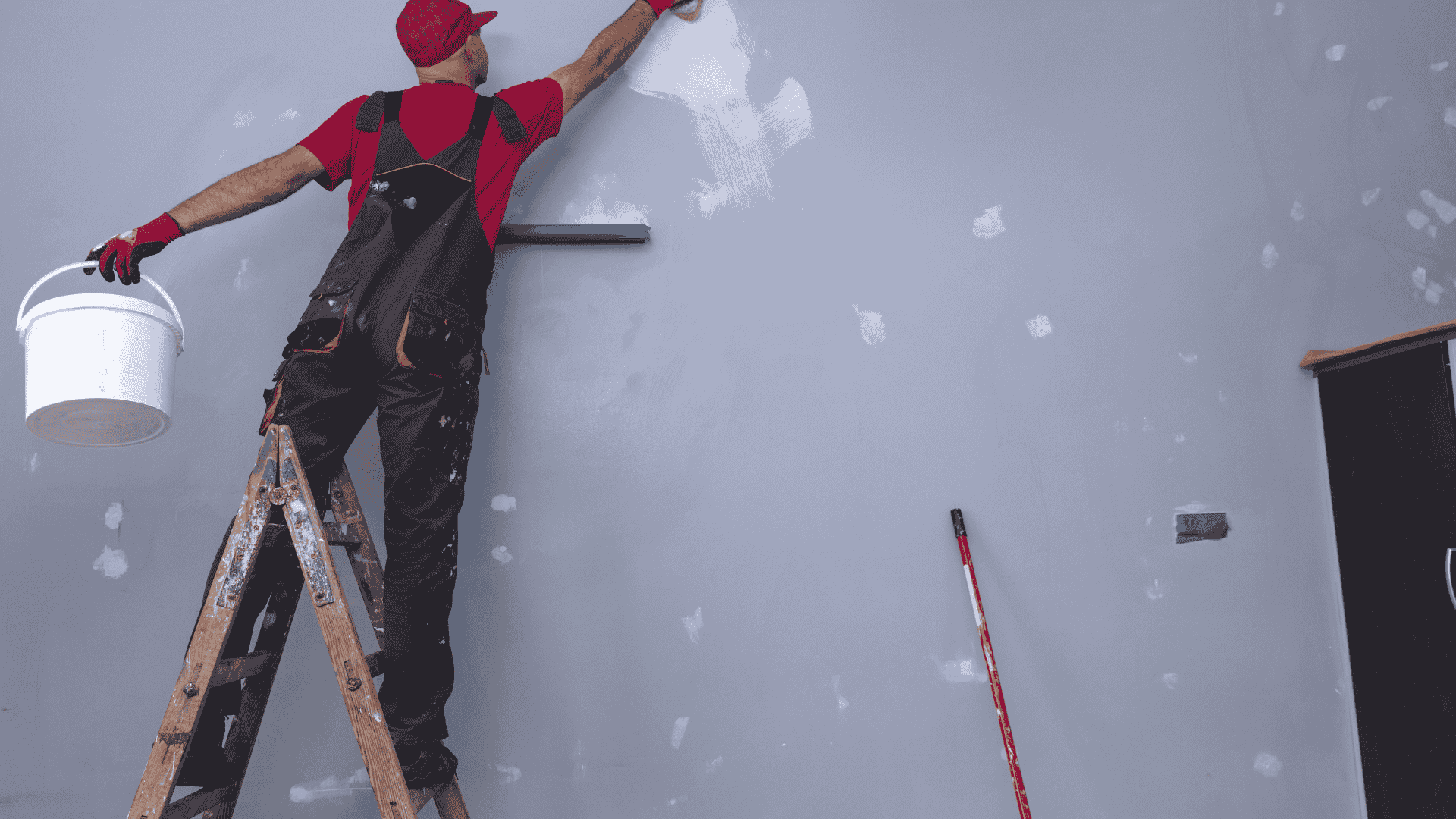 painter applying wall paint inside residential property Dallas Fort Worth