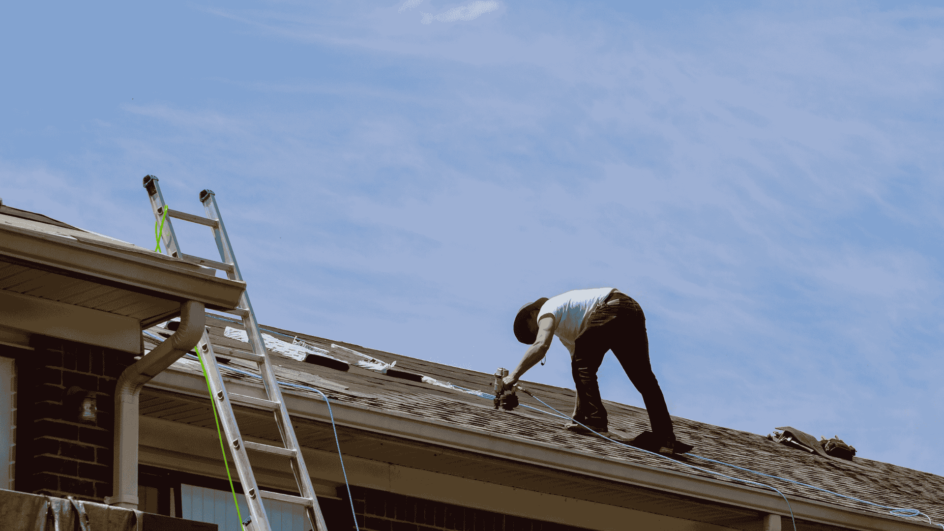 roofer repairing damaged roof shingles Dallas Fort Worth