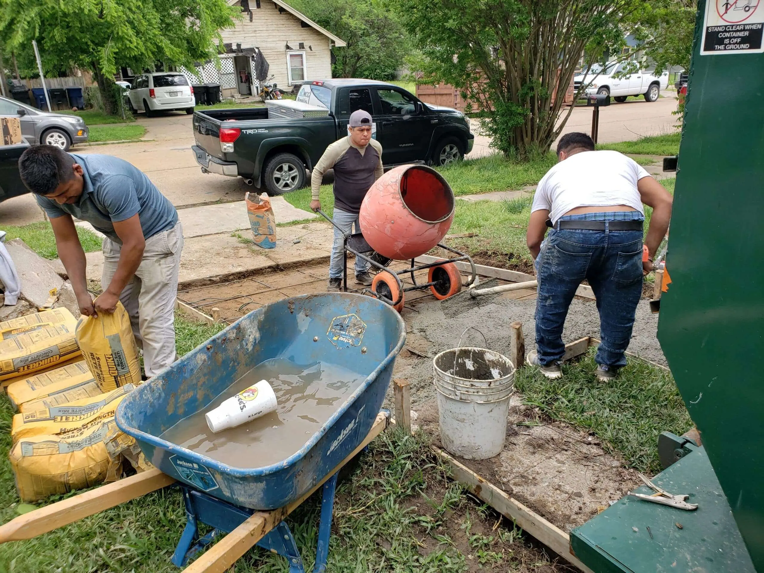 workers pouring and leveling concrete driveway Dallas Fort Worth