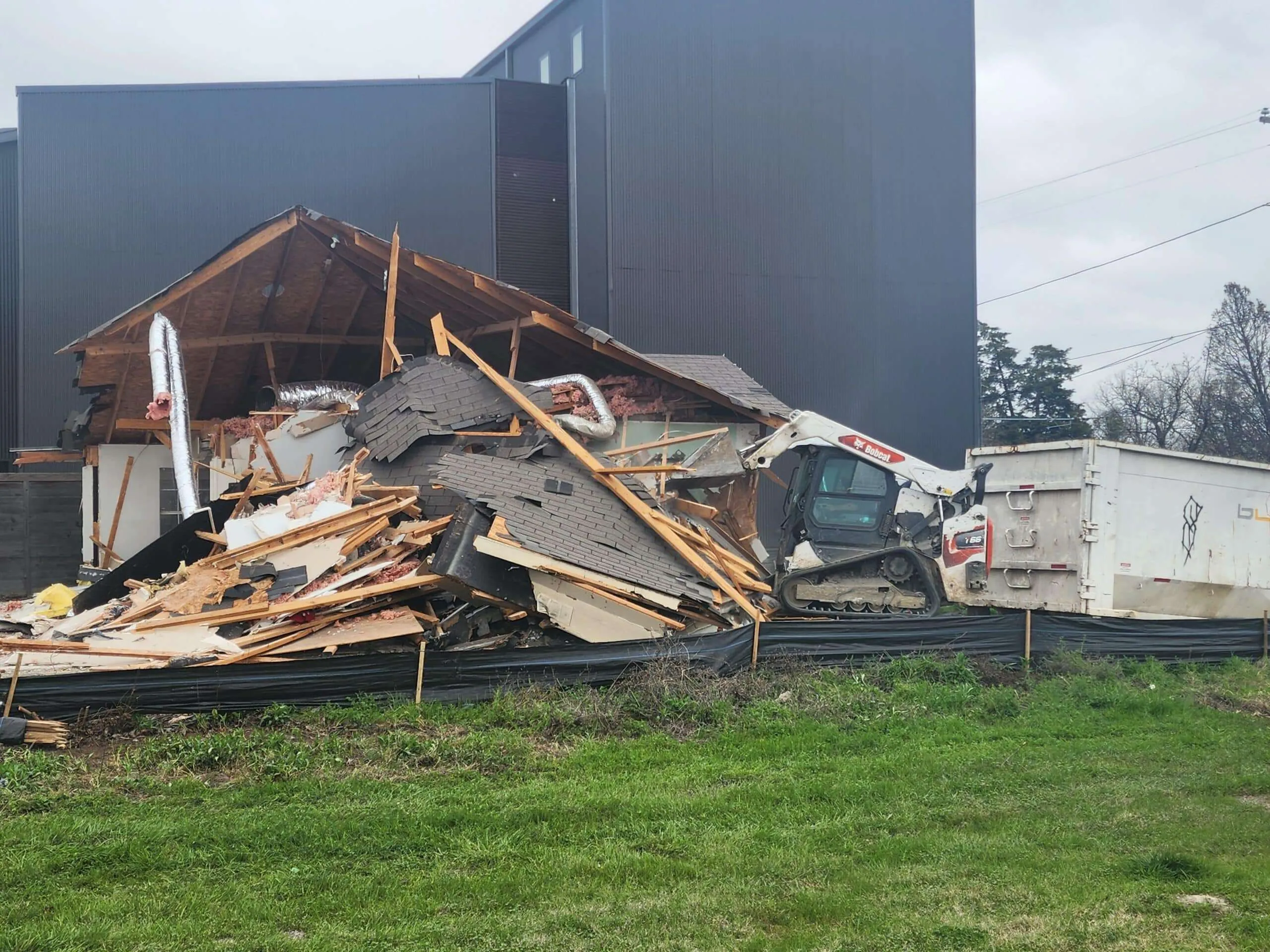 excavator demolishing residential structure and clearing debris Dallas Fort Worth