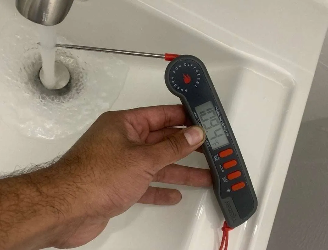 technician checking water temperature and plumbing system in Dallas Fort Worth