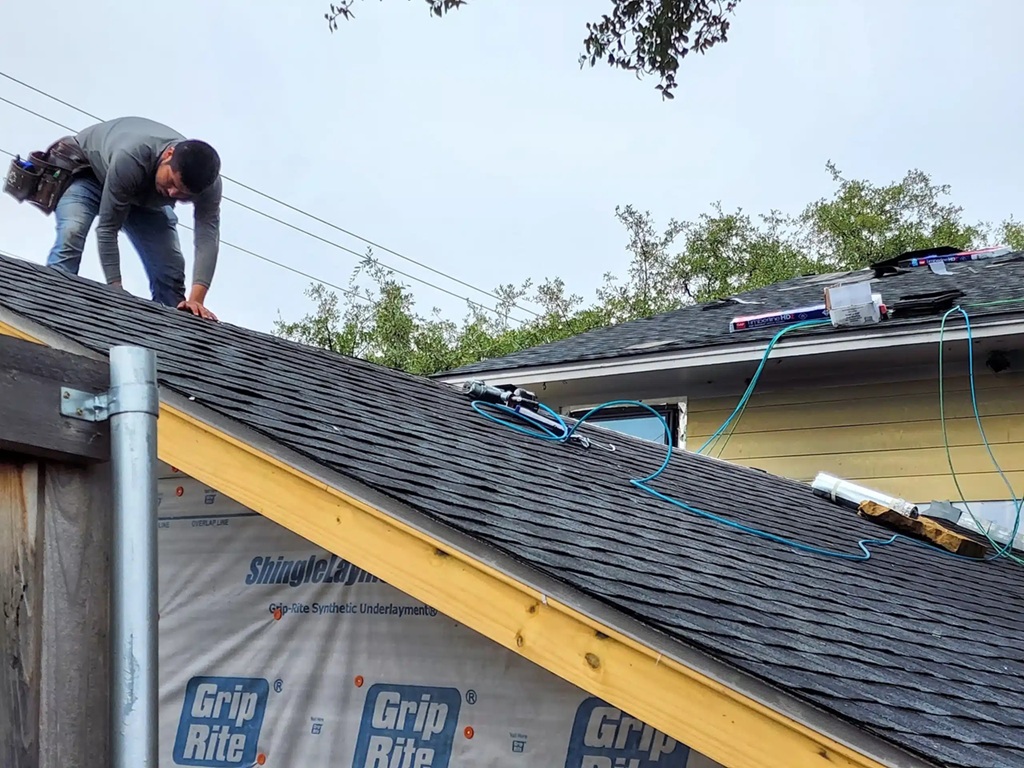 roofing contractor installing shingles on residential roof Dallas Fort Worth