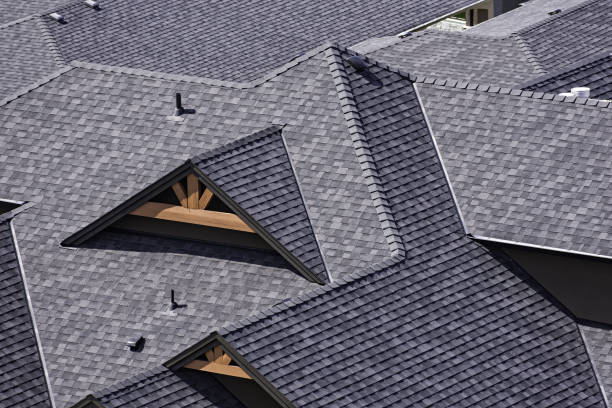 Homeowner meeting roofer beside Murphy house to review storm-related roof concerns