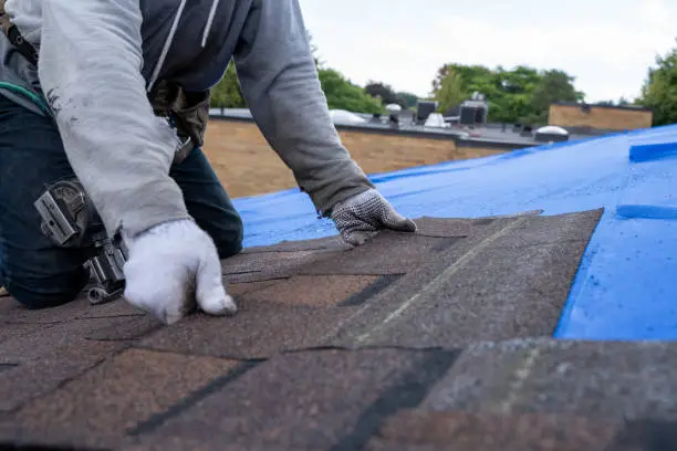 Roofing team inspecting shingle wear on a suburban home in Anna