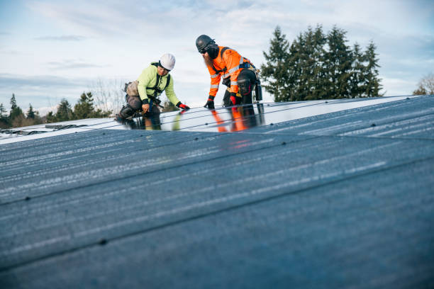 Skilled roofer inspecting roof system details and drainage points with trained focus