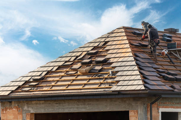 Roofing professional inspecting shingle damage and flashing condition on steep residential roof