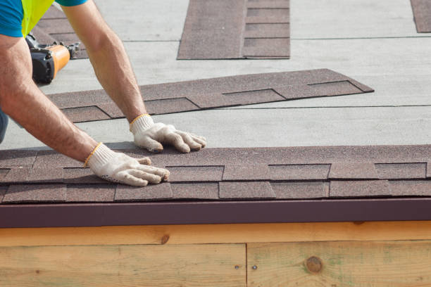 Roofing crew inspecting flashing and shingle wear on Richardson home after heavy rain