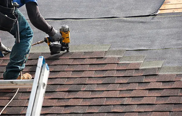 Skilled roofer checking roof penetrations and flashing for hidden water entry, Experienced roofer evaluating storm wear and roof ventilation with professional inspection tools, Skilled roofer inspecting hail damage and flashing with close attention to roof details