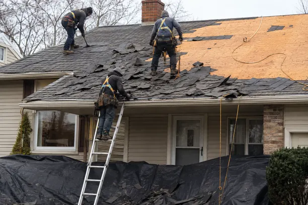 Roof Replacement in Anna - TX underway as a crew removes worn shingles from a suburban home