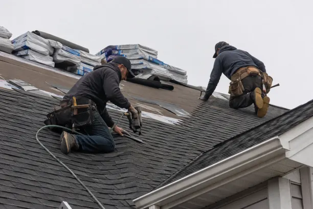 Roof replacement specialists in Murphy - TX examining worn shingles and flashing before installing a new system
