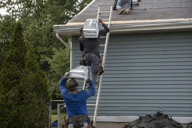 Roof Replacement in Carrollton - TX in progress as roofers remove worn shingles from a family home